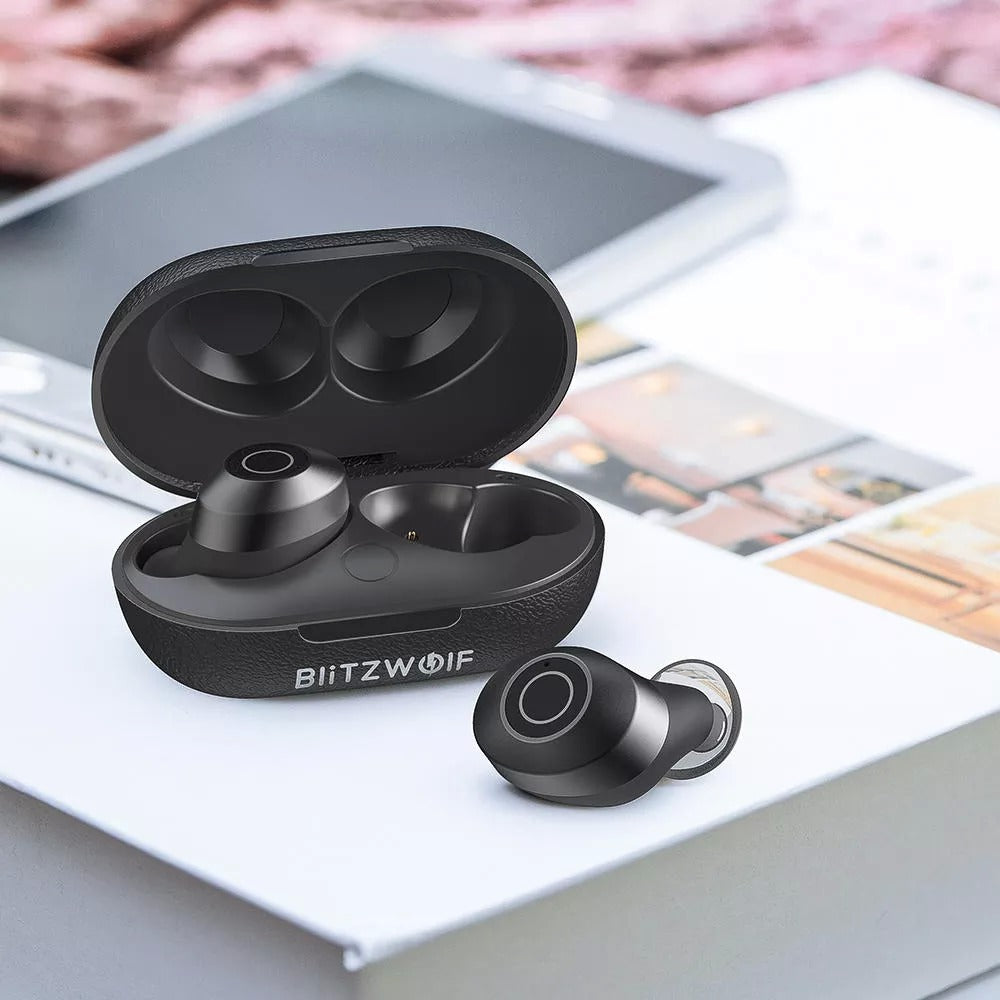 Black wireless earbuds with charging case on a surface